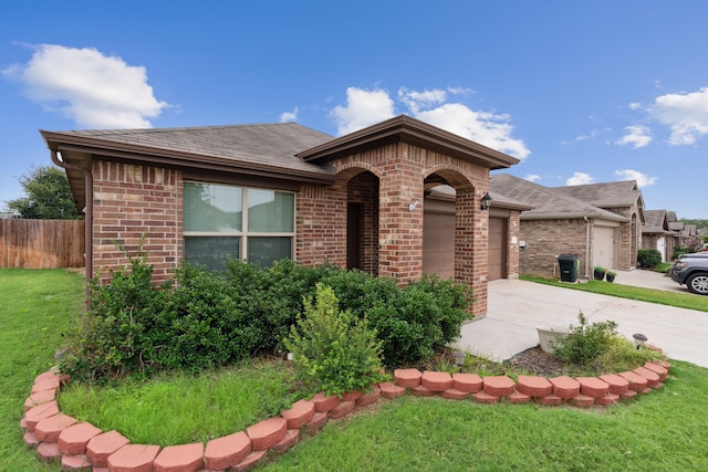 view of front of property featuring a garage and a front lawn