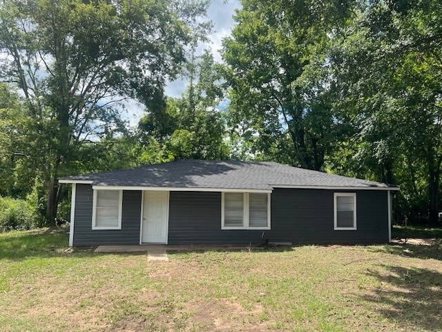 ranch-style home with a front lawn