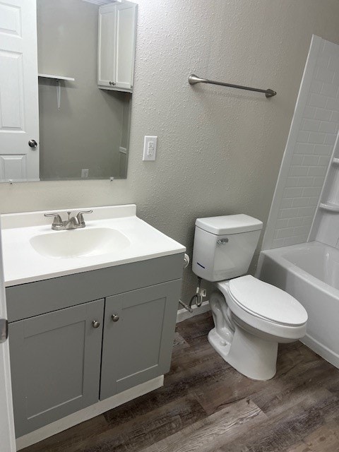 full bathroom featuring toilet, shower / bath combination, hardwood / wood-style floors, and vanity