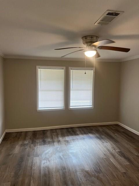 empty room with ornamental molding, ceiling fan, and dark hardwood / wood-style floors