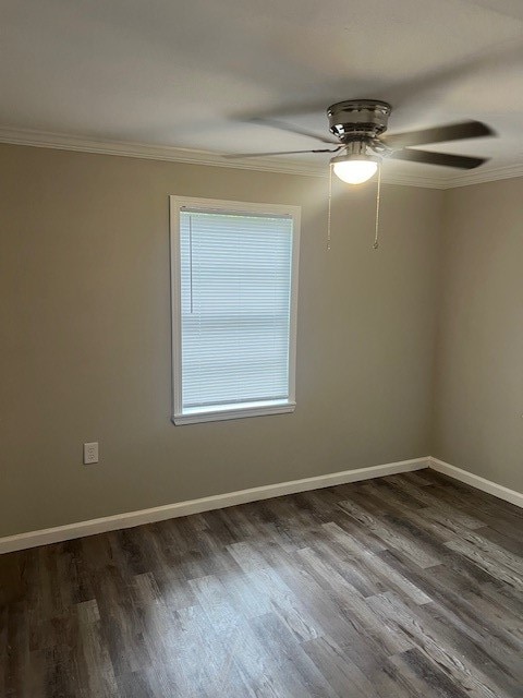 empty room with hardwood / wood-style flooring, crown molding, and ceiling fan