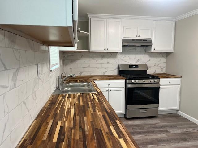 kitchen featuring stainless steel gas range, white cabinetry, wooden counters, sink, and dark wood-type flooring