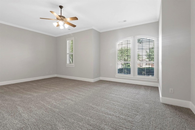 empty room with ceiling fan, ornamental molding, and carpet floors