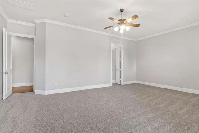 spare room featuring carpet flooring, crown molding, and ceiling fan