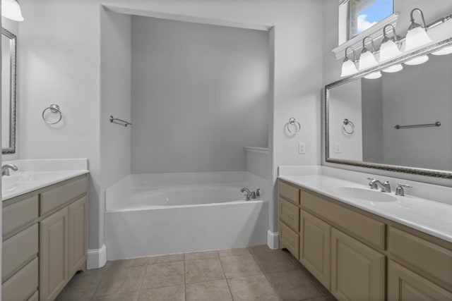 bathroom featuring tile patterned floors, vanity, and a tub to relax in