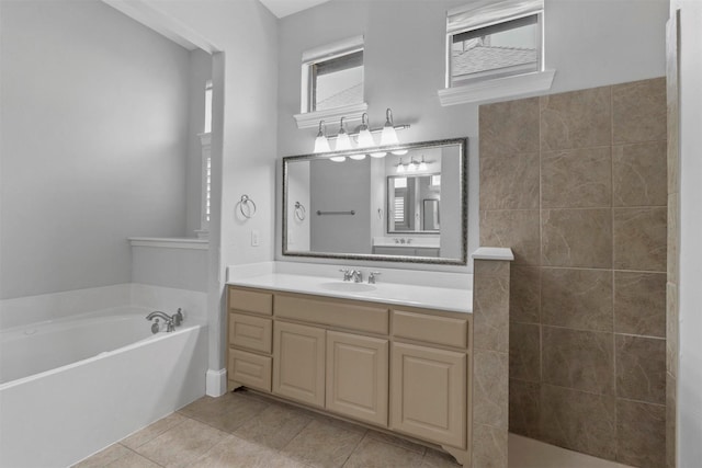 bathroom featuring tile patterned floors, vanity, and shower with separate bathtub