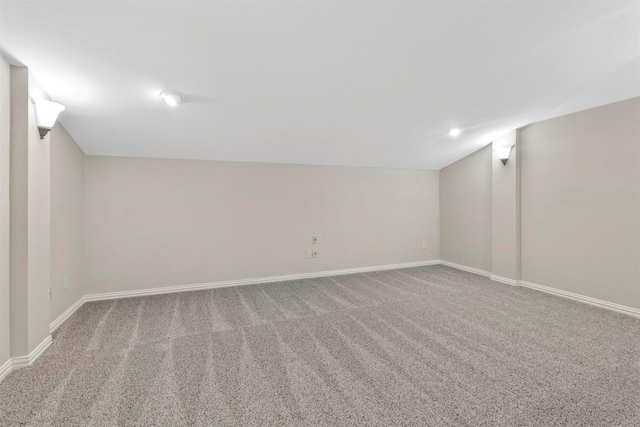 basement featuring light colored carpet