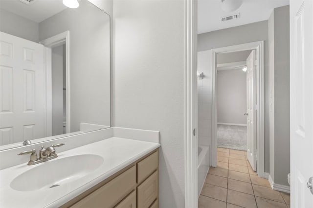 bathroom with tile patterned floors, vanity, and tub / shower combination