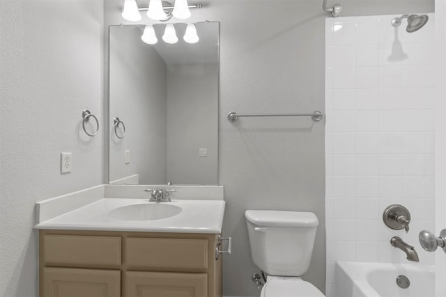 full bathroom with vanity, toilet, and tiled shower / bath