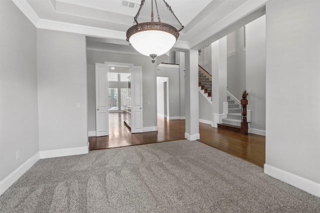 empty room with dark colored carpet and ornamental molding