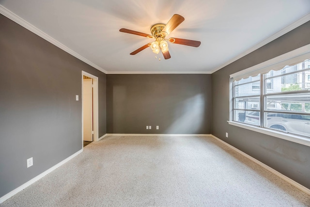 empty room with ceiling fan and crown molding