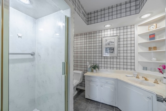 bathroom featuring toilet, built in features, tile patterned floors, an enclosed shower, and vanity