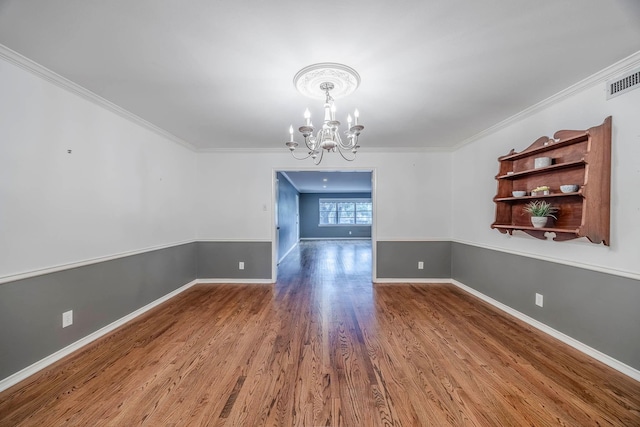 unfurnished dining area featuring an inviting chandelier, ornamental molding, and hardwood / wood-style flooring