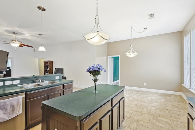 kitchen with sink, light tile patterned floors, a kitchen island, stainless steel dishwasher, and ceiling fan