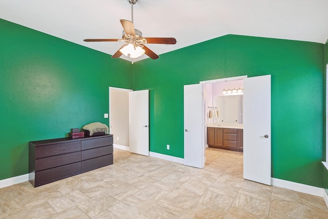 tiled bedroom with vaulted ceiling, ensuite bathroom, and ceiling fan