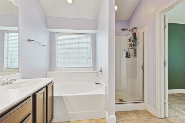 bathroom with tile patterned floors, plus walk in shower, and vanity