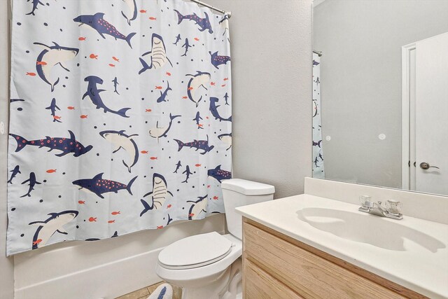 full bathroom with tile patterned flooring, shower / bath combo, toilet, and vanity