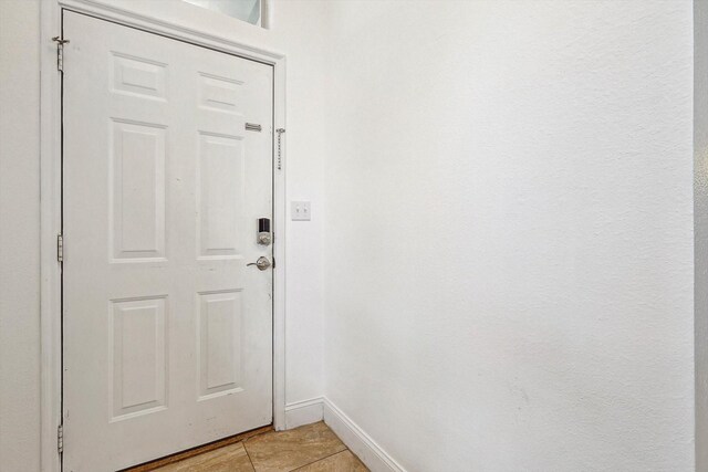 entryway with light tile patterned flooring