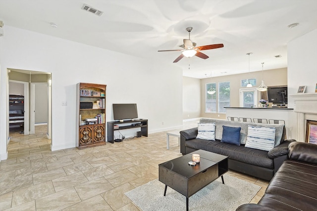 tiled living room with ceiling fan