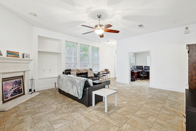 tiled living room with built in shelves and ceiling fan