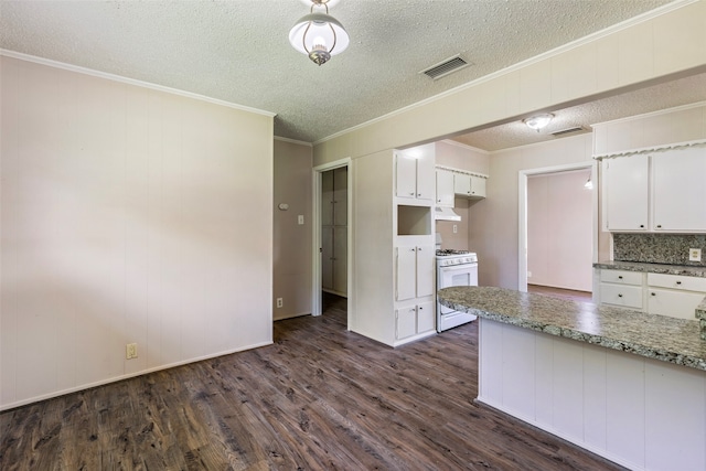 kitchen with a textured ceiling, white cabinets, wall chimney range hood, dark hardwood / wood-style flooring, and white range with gas cooktop