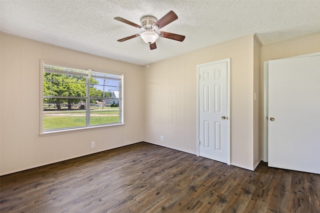 unfurnished bedroom with dark hardwood / wood-style floors, a textured ceiling, and ceiling fan