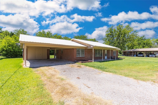 ranch-style home with a carport and a front lawn