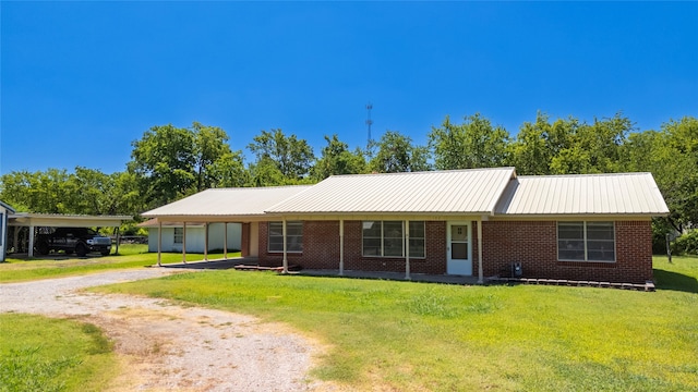 single story home featuring a carport and a front lawn