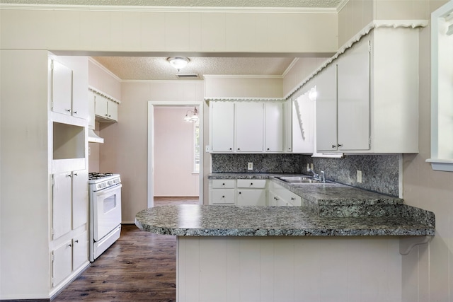 kitchen featuring white cabinets, kitchen peninsula, white range with gas stovetop, decorative backsplash, and dark hardwood / wood-style floors