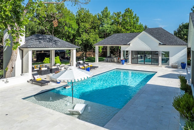 view of swimming pool featuring an outdoor hangout area, a patio, and a gazebo