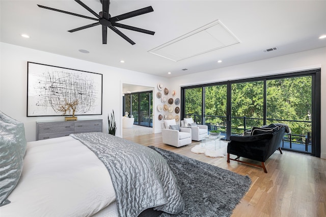 bedroom featuring ceiling fan, access to exterior, and light hardwood / wood-style flooring