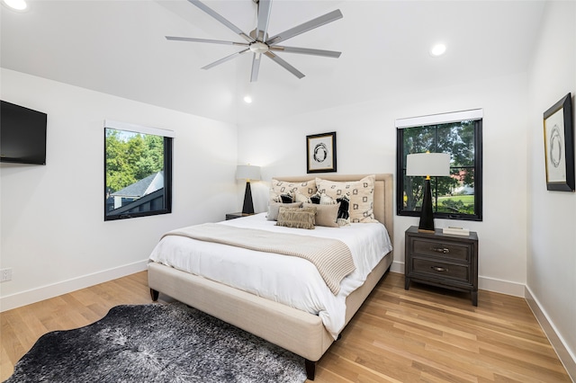 bedroom with ceiling fan and light hardwood / wood-style flooring