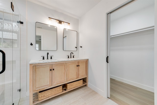 bathroom featuring vanity, tile patterned flooring, and a shower with door