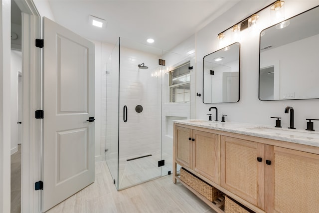 bathroom with tile patterned floors, walk in shower, and vanity