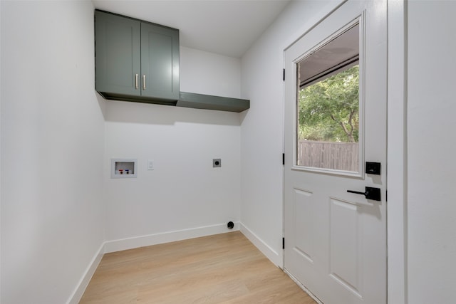 laundry room featuring light wood-type flooring, hookup for an electric dryer, hookup for a washing machine, and cabinets