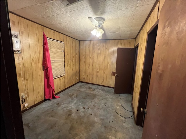 spare room with wood walls