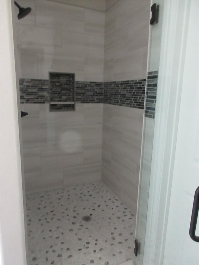 bathroom with a shower with shower door