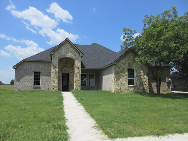 french provincial home featuring a front lawn