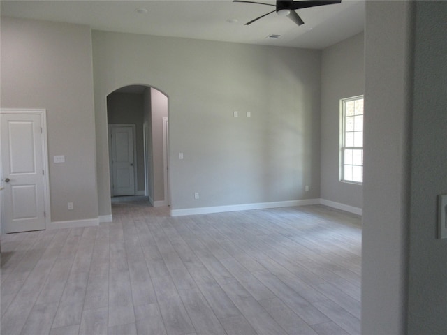 empty room featuring ceiling fan and light hardwood / wood-style flooring