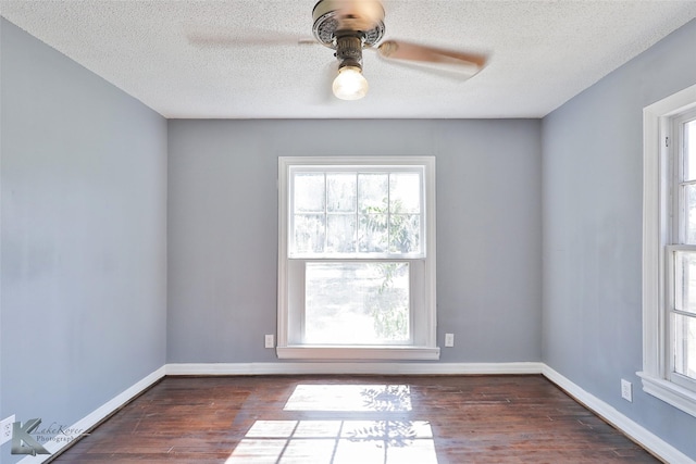 unfurnished room with ceiling fan, dark wood-type flooring, and a textured ceiling