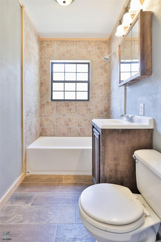 bathroom with vanity, a wealth of natural light, and toilet