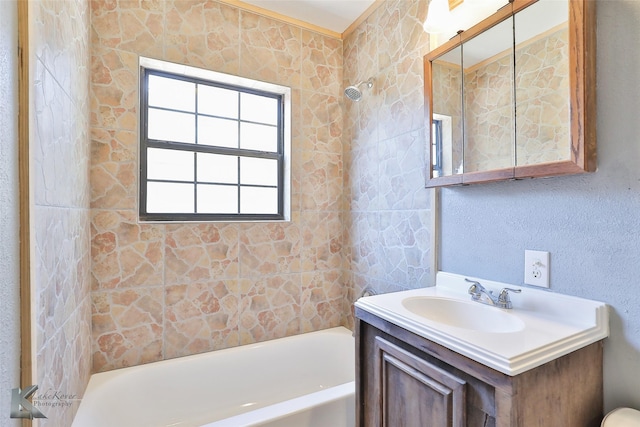 bathroom with vanity and tiled shower / bath