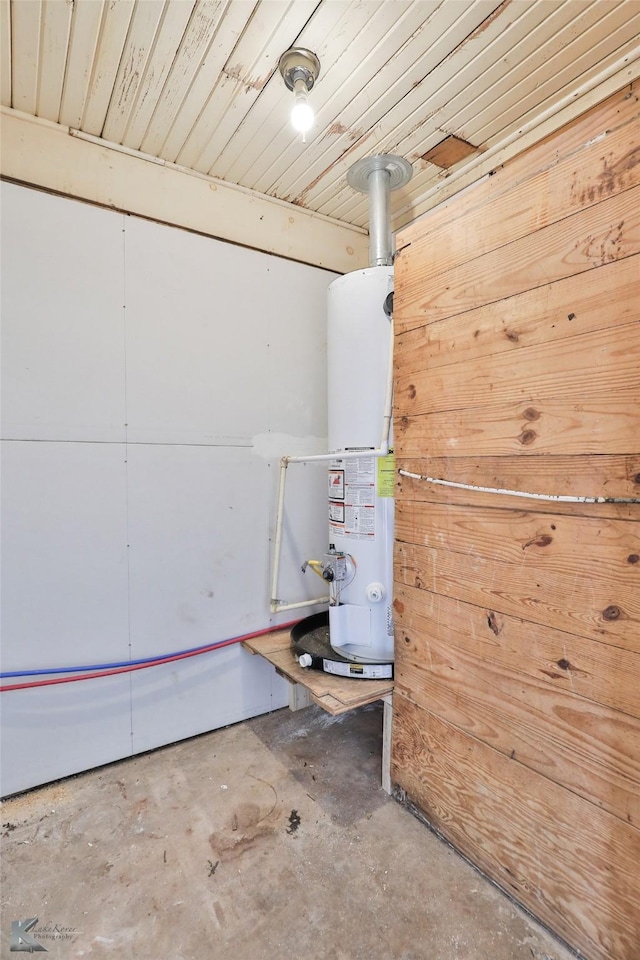 basement featuring wood ceiling and gas water heater