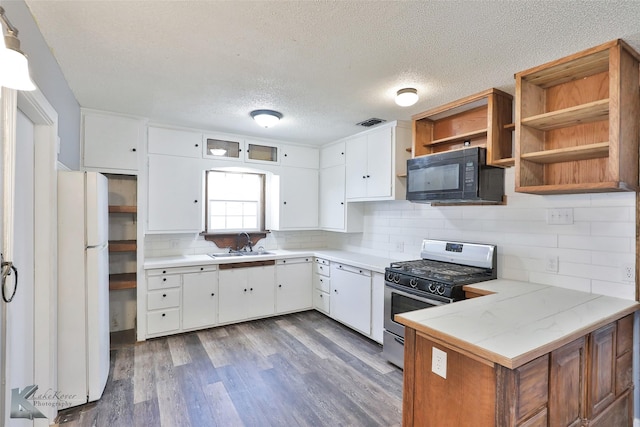 kitchen featuring sink, white appliances, kitchen peninsula, and white cabinets