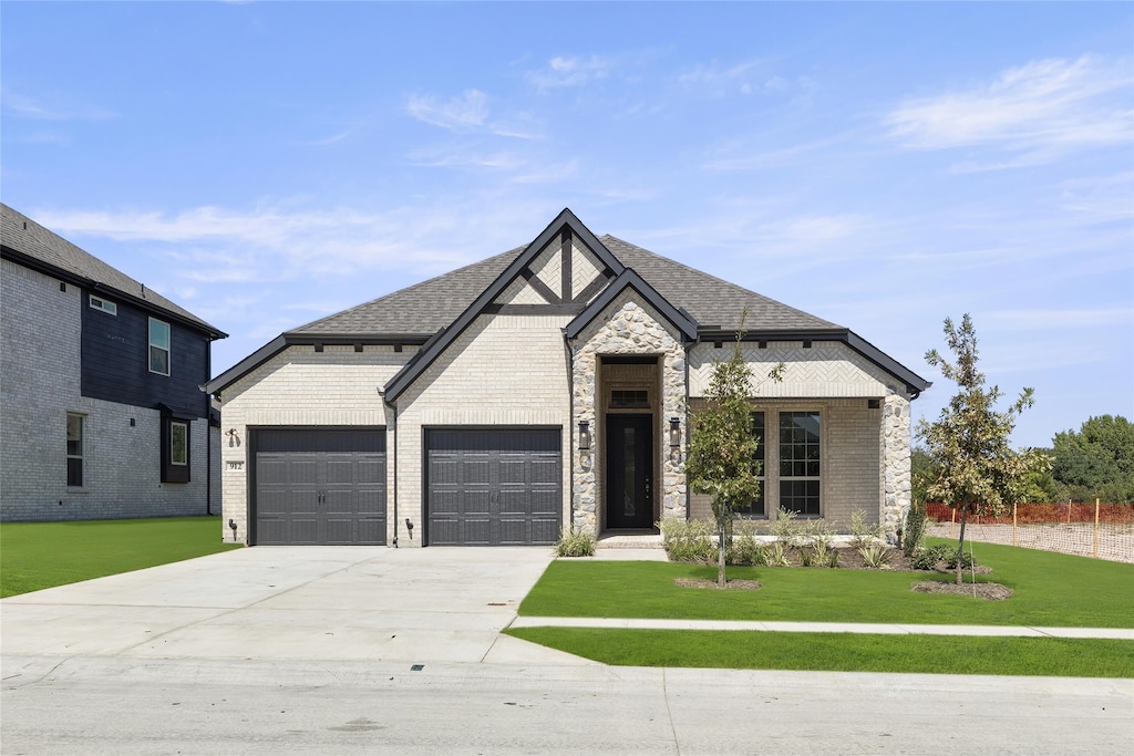 912 Pilatus Ln, Fate, TX 75087 - french provincial home featuring roof with shingles, brick siding, concrete driveway, a garage, and a front lawn
