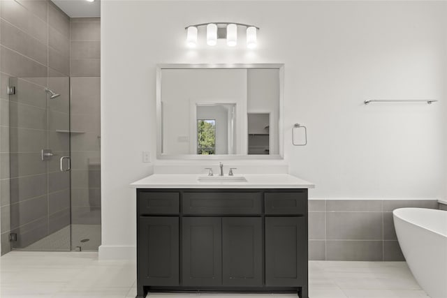 bathroom with tile walls, vanity, tile patterned floors, a stall shower, and a soaking tub