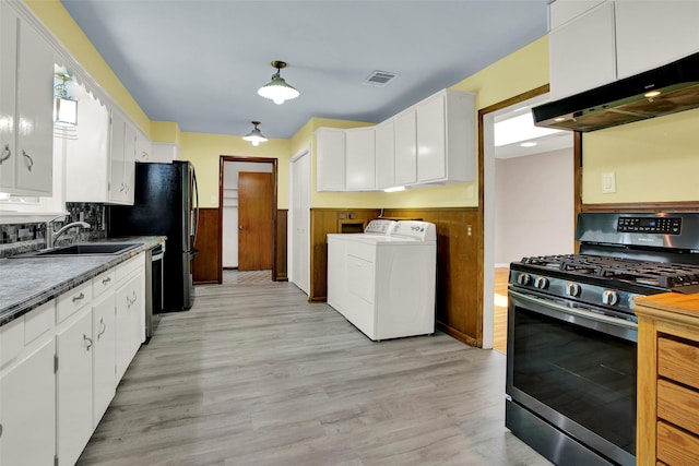 kitchen featuring separate washer and dryer, white cabinetry, extractor fan, and appliances with stainless steel finishes