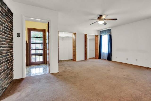 spare room featuring ceiling fan and light carpet