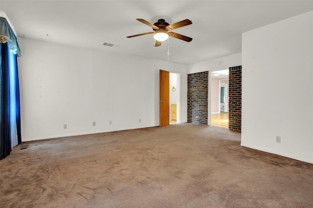 spare room with ceiling fan and carpet