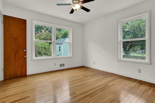 empty room with light wood-type flooring and ceiling fan